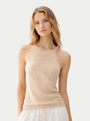 Woman wearing a beige sleeveless cashmere top against a light background. #color_beige