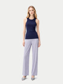 Woman wearing a navy sleeveless top and light gray wide-leg pants on a white background #color_dark-indigo
