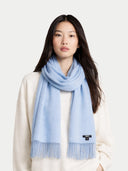 Woman wearing a light blue scarf with a white background