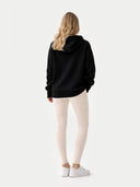 Women's Cashmere Pullover Hoodie Black worn by model, back view on white background