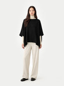 Women's Boat-Neck Cashmere Poncho Black worn by model, front view on white background
