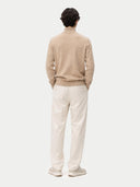 Man wearing a beige turtleneck cashmere sweater against a white background. #color_soft-beige