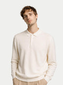 Man wearing a white sweater and beige pants on a white background #color_cream-white