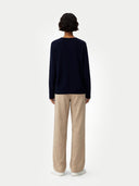 Women's Navy Cashmere V-Neck Sweater worn by model, back view on white background