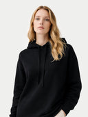Women's Cashmere Pullover Hoodie Black worn by model, detail view on white background