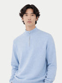 Man wearing a light blue cashmere sweater against a white background. #color_muted-blue