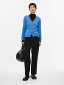 Blue cashmere cardigan on a light gray background. #color_blue