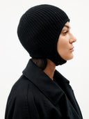 Unisex Cashmere Knitted Aviator Cap Black worn by model, detail view on white background