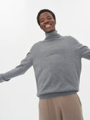 Men's Dim Gray Cashmere Turtleneck Sweater worn by model, detail view on white background
