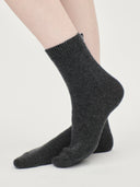 Set of black blanket, eye mask, and socks on a white background #color_charcoal