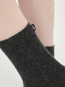 Set of black blanket, eye mask, and socks on a white background #color_charcoal