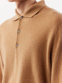a beige cashmere polo sweater with a round neckline and long sleeves. #color_light-brown