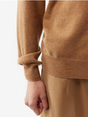 a beige cashmere polo sweater with a round neckline and long sleeves. #color_light-brown