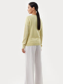 Women's  Tender Yellow Cashmere V-Neck Sweater worn by model, back view on white background  