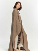 Side view of model wearing the taupe throw as a long wrap