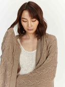 Close view of the taupe wrap draped over the shoulders of a model