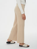Women's Cashmere Pants Beige worn by model, side view on white background