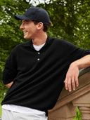 Men's Black Cashmere Polo Sweater worn by model, detail view on white background
